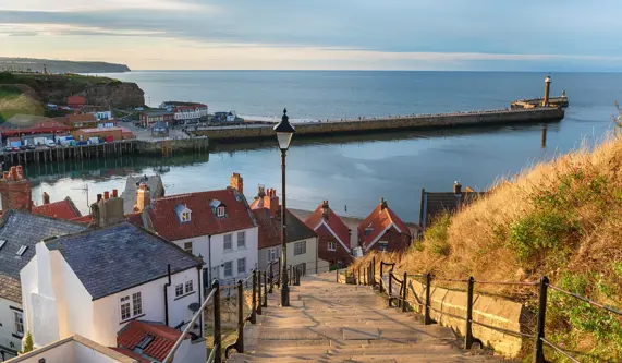 small fishing village with view of the sea at sunset